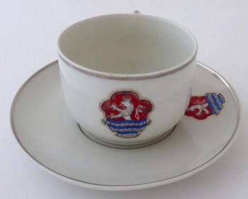 Cup with a saucer and the emblem of the city 
